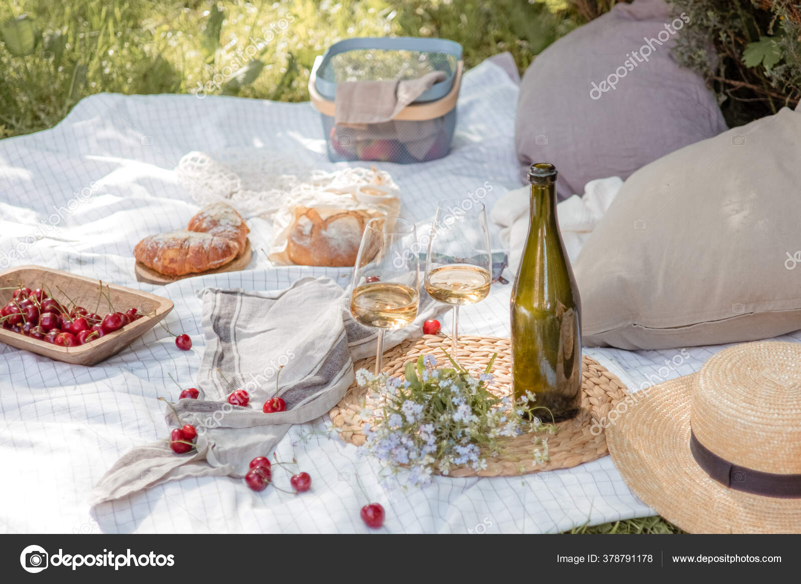 Aesthetic picnic outdoors with wine glasses bread berries and flowers.  Rustic picnic with neutral tones colours. Stock Photo by  ©lamapacas.gmail.com 378791178