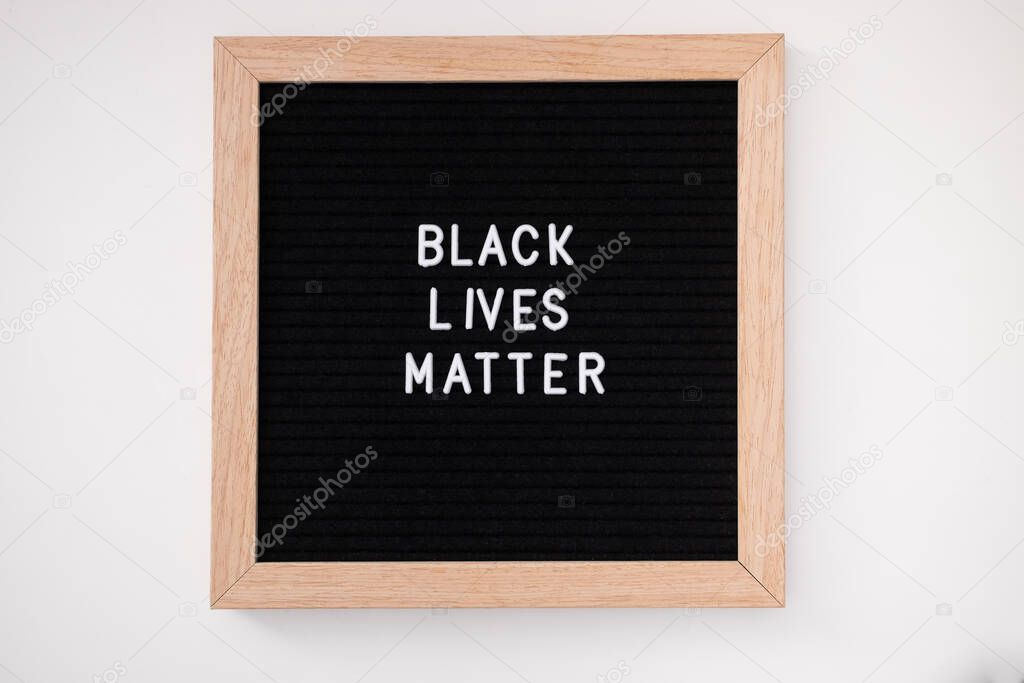 Felt letter board with words black lives matter on white backgroung.