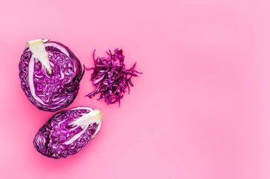 Kırmızı lahana - kafası kesilmiş ve dilimlenmiş - pembe masa üzerinde fotokopi uzayından
