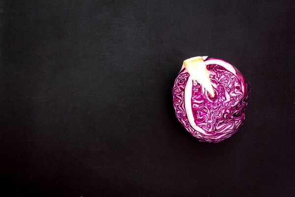 Red cabbage - head, cross section - on black background top view space for text