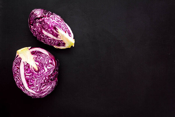 Red cabbage on black table top down copy space