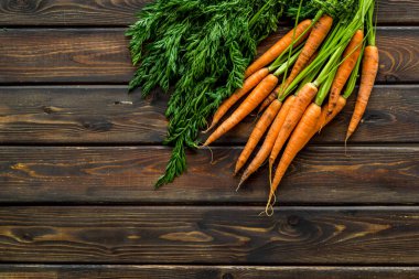 Fotokopi alanının üzerinde yeşil başlıklı taze havuçlar var.