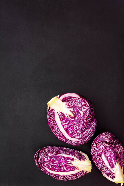 Red cabbage on black table top down copy space