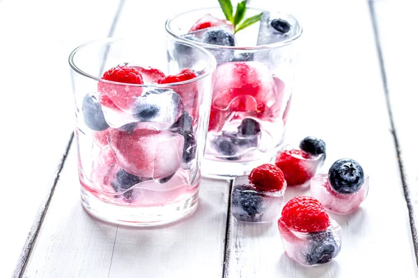 Gefrorene Beeren im Glas für Cocktails auf Holztischhintergrund — Stockfoto