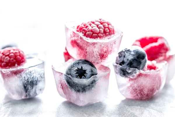 Arándano fresco y frambuesa en hielo sobre fondo de mesa — Foto de Stock