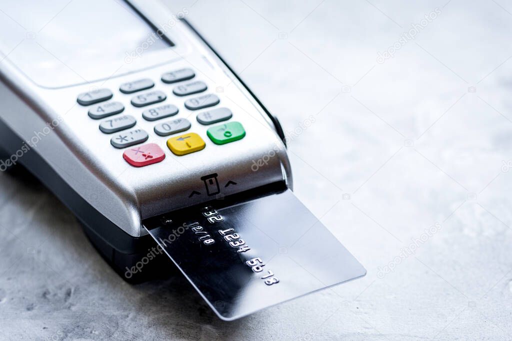 terminal and card in purchasing concept on stone table background