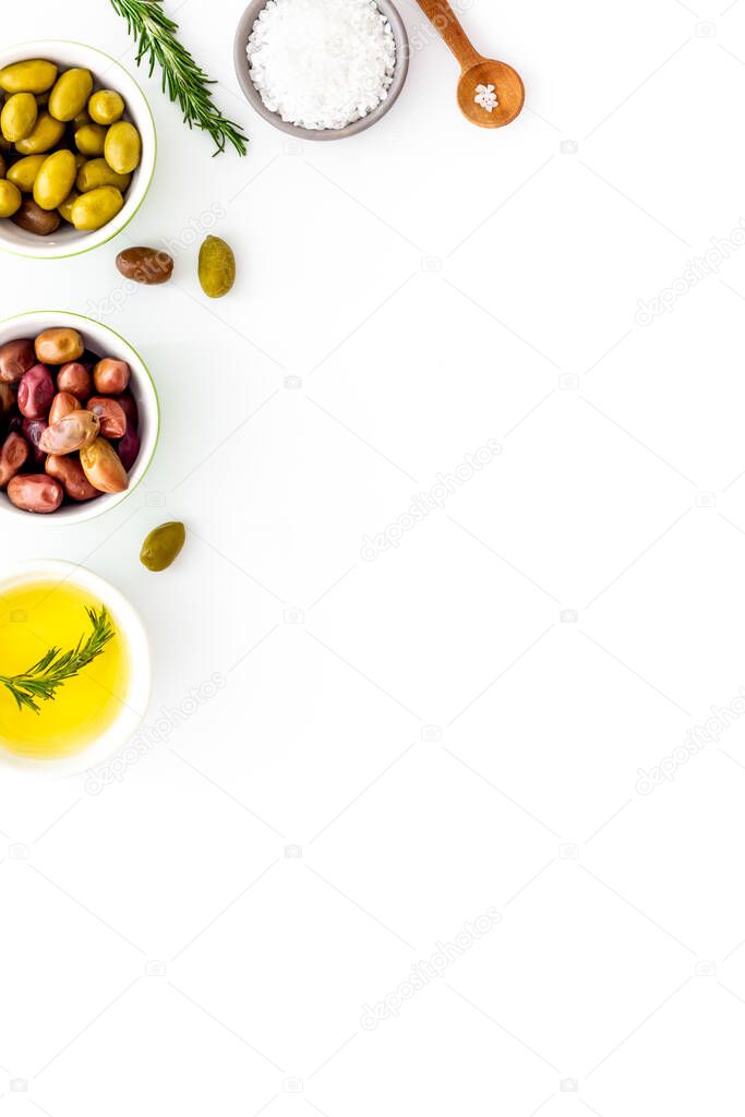 Olive oil in bowl near oilves from above copy space