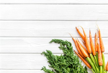 Fotokopi alanının üzerinde yeşil başlıklı taze havuçlar var.