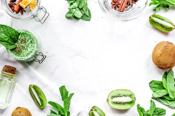 Cosmetic for body with kiwi scrub table background top view mockup