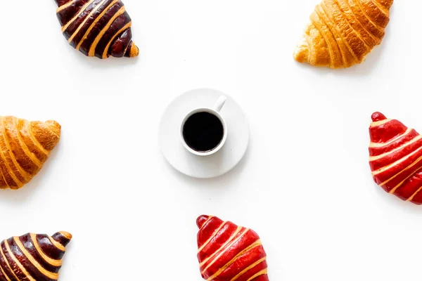 Frame of croissants - fresh bakery on white background. Top view