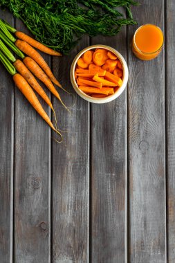 Tahta masa üzerinde dilimlenmiş havuç ve meyve suyu fotokopi alanı