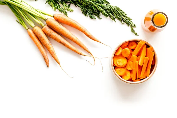 Carrot slices, fresh juice, vegetable with green tops top view copy space — Stock Photo, Image