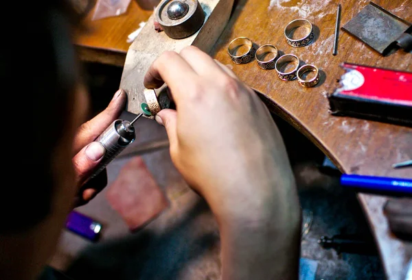 Master polish ring at jewelry workshop