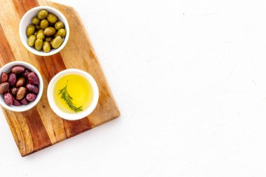 Tabaklarda zeytin ve zeytin yağı beyaz üst görünüm kopyalama alanının tahtasını kesiyor.