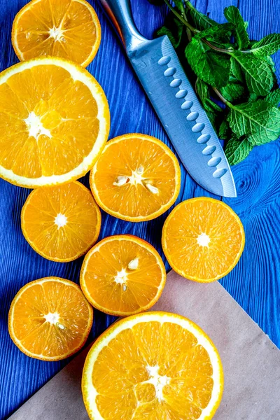 Homemade orange smoothie making on blue wooden table top view — Stock Photo, Image