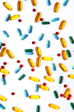 Beyaz arka planda izole edilmiş renkli tıbbi haplar.