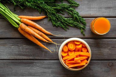 Havuç dilimleri, taze meyve suyu, sebzeler, en üstteki yeşil manzaralı fotokopi alanı.