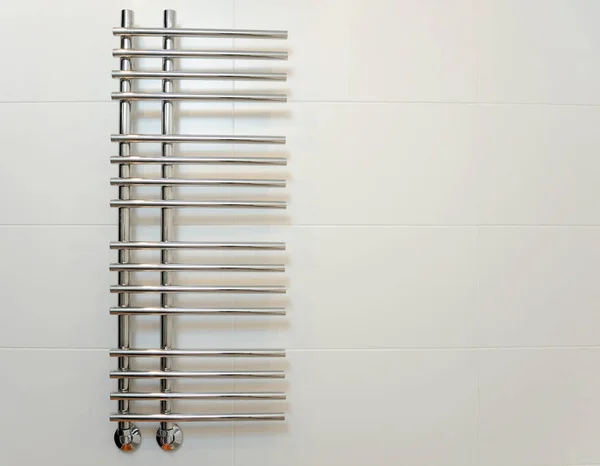 Heated towel rail in the bathroom. Towel warmer in bathroom.