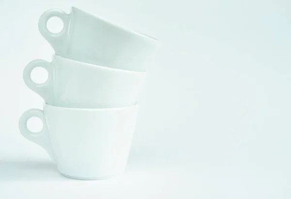 Three white coffee cups on a white background