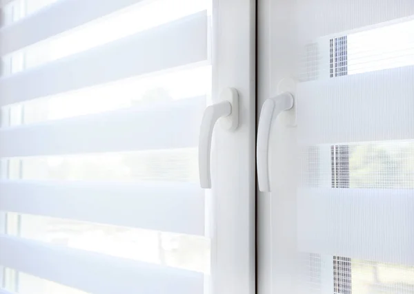 Window with white jalousie, close up.Windows with white venetian blinds. Close-up view.