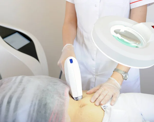 Woman gets laser and ultrasound treatment of face and body at medical spa, skin rejuvenation concept
