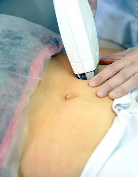 Woman gets laser and ultrasound treatment of face and body at medical spa, skin rejuvenation concept