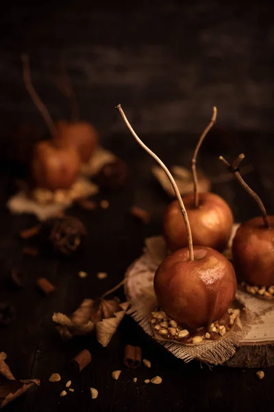 Autumn mood background. Old fashioned toffee apples with twig sticks.