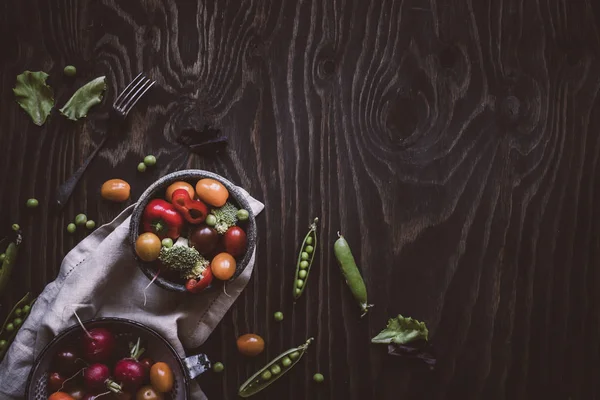 Verduras orgánicas frescas. Guisantes verdes, brócoli, tomate y rábano en la mesa de madera. Vista superior . —  Fotos de Stock