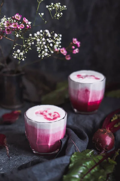 Beetroot latte. Healthy beetroot drink on table close up.