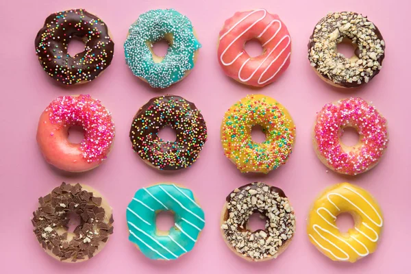 Fundo doce colorido. Deliciosos donuts envidraçados em fundo rosa . Fotos De Bancos De Imagens Sem Royalties