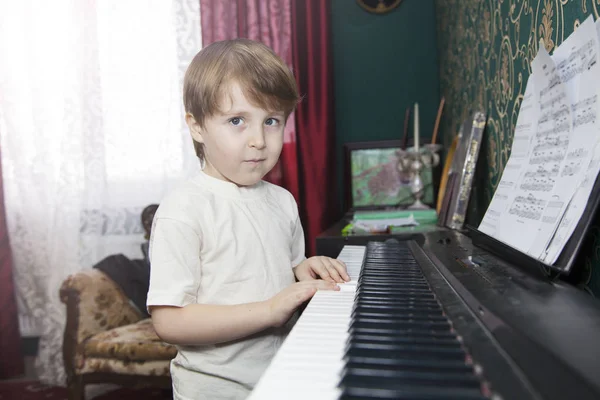 Little boy Learn to play the synthesizer, home music training