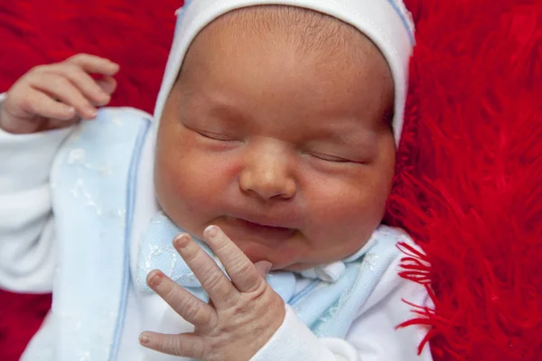Новорожденный Мальчик Спит Красном Фоне Меха Тепла — стоковое фото