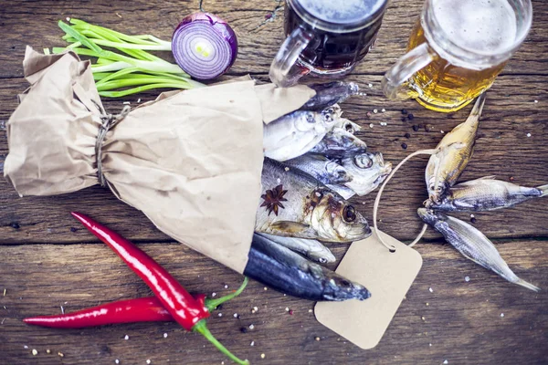 Dry fish on wooden background with beer,Bouquet from dry different fish, toned.