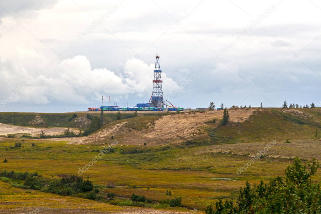 Oil and gas drilling rigt with landscape of forest-tundra, 