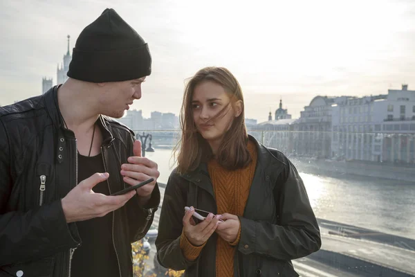 young couple with mobile phones, the problem of communicating with each other, virtual communication on mobile phones