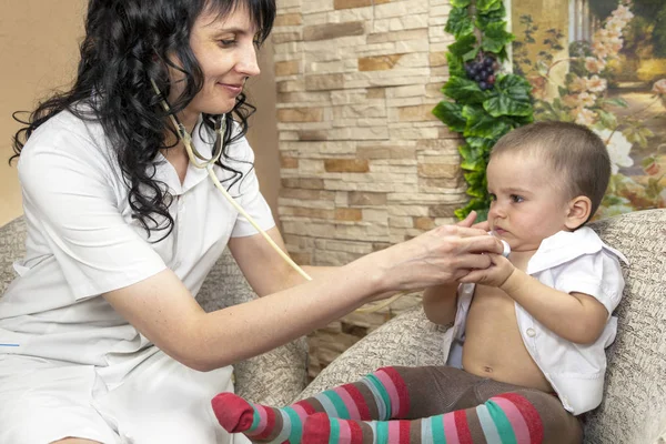 Portrait of a little boy, visiting doctor,the pediatrician listen to a heartbeat with a stethoscope