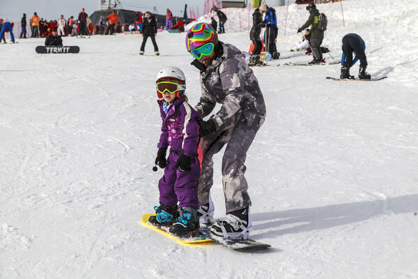 Russia, Sochi, December 01, 2017 - ski resort, instructor is teaching a young girl to ski, instructor is teaching a young girl to ski, Opening of the ski season,editorial.