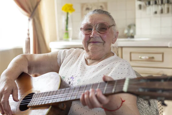 90 year old grandmother plays guitar