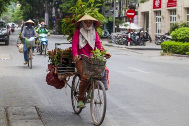 old quarter of hanoi. Street sellers sell fruit from their bikes clipart