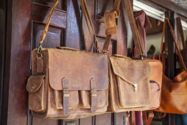 Hoi An, Vietnam. Şehrin eski mahallesi, alışveriş caddesi, deri çantalar, omuz çantaları. Farklı renklerde boyanmış