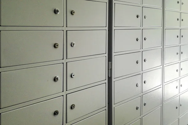 metal cabinets cells for storing things, money, mail. Safe deposit boxes background. Closed metal lockers in a bank vault for storing safely valuables jewels, money,