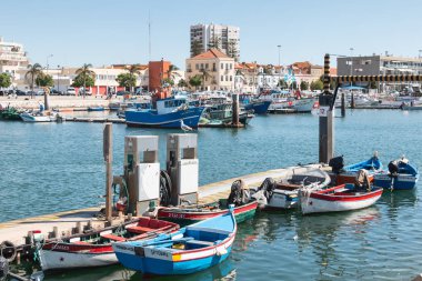 Setubal, Portugal - August 8, 2018: view of the small fishing port of Setubal with its typical blue boats on a summer day clipart