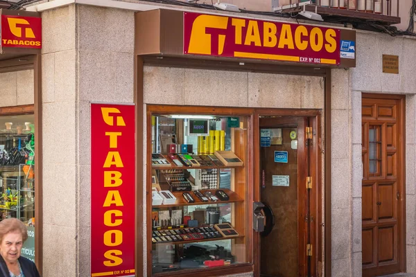 stock image Toledo, Spain - April 28, 2018 - grandmother who passes a tobacco shop in the historic center of the city a spring day