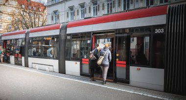 Bir Freiburg im Breisgau, Almanya - 31 Aralık 2017: bir elektrik tramvay tarihi şehir merkezinde bir kış gününde yatılı yolcu
