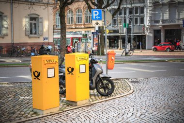 Freiburg im Breisgau, Germany - December 31, 2017: Yellow post office boxes in the city center on a winter day