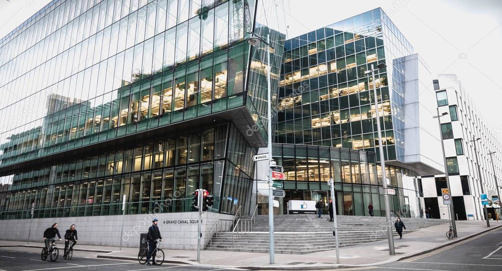 Dublin, Ireland - February 12, 2019 - cyclists passing by the Irish social seat of Facebook's international social network on a winter day
