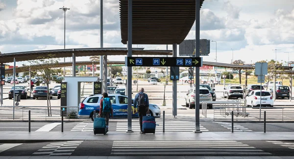 Kiutazó utasok bőröndon a Faro parkolóban — Stock Fotó