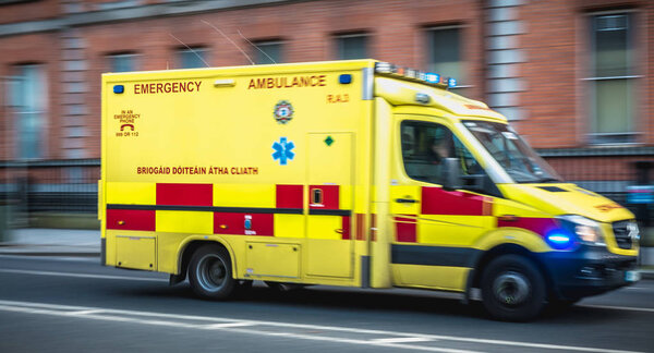  Irish ambulance driving fast on the streets of Dublin, Ireland