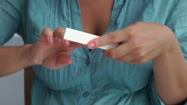 Home manicure and nail care concept. Woman using nail file for make shape to nails while home manicure. Woman doing yourself home manicure. — Stock Video