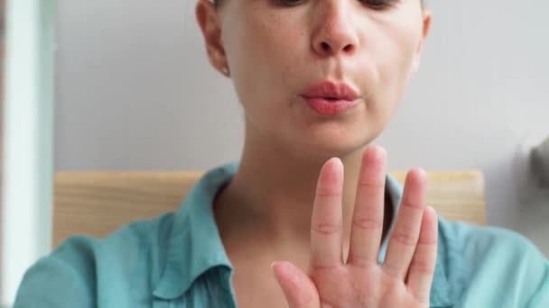 Giovane donna che soffia a secco smalto dopo l'applicazione. Donna asciugatura lacca per unghie mentre manicure a casa. Casa manicure, bellezza e cura concetto . — Video Stock